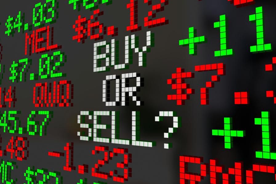 "buy or sell?" written on ticker board
