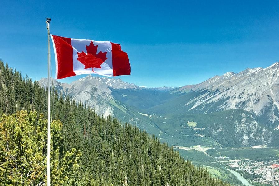canada flag against mountain