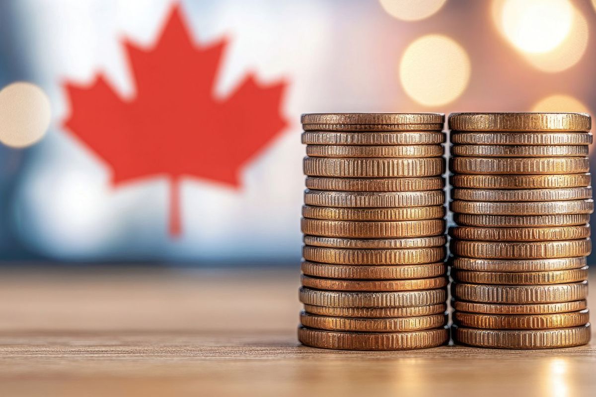 Canadian flag with two stacks of coins.