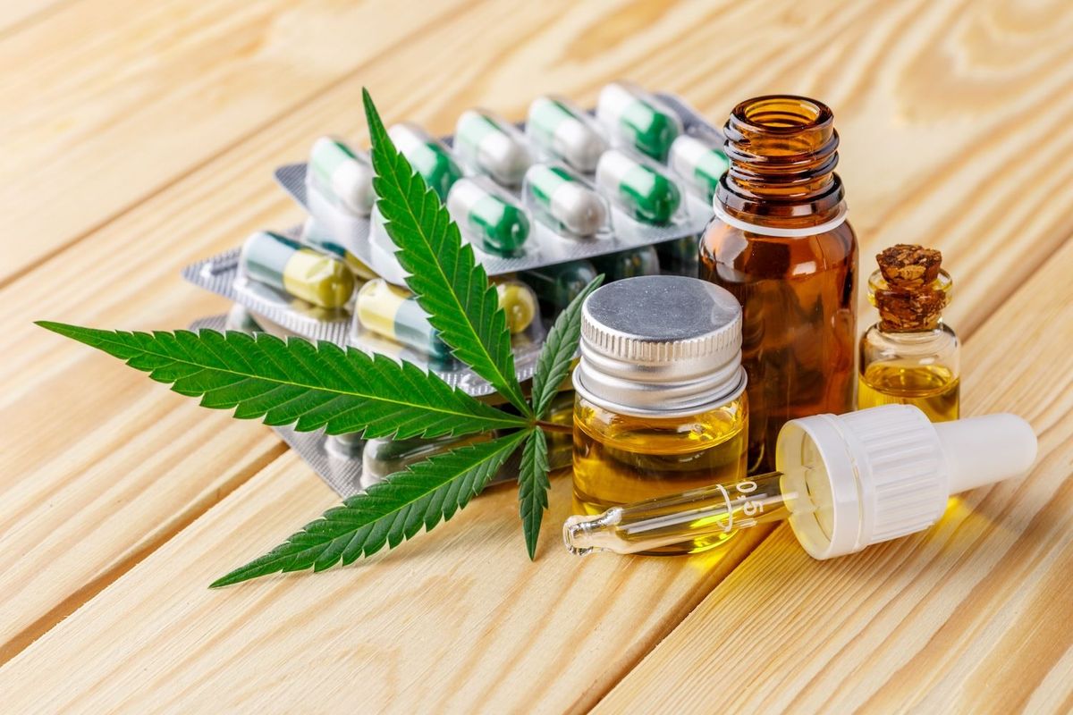 Cannabis leaf with capsules, tinctures and oils.