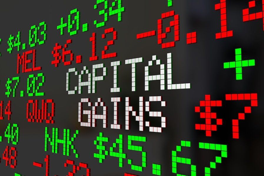 "Capital gains" written on a stock ticker board. 