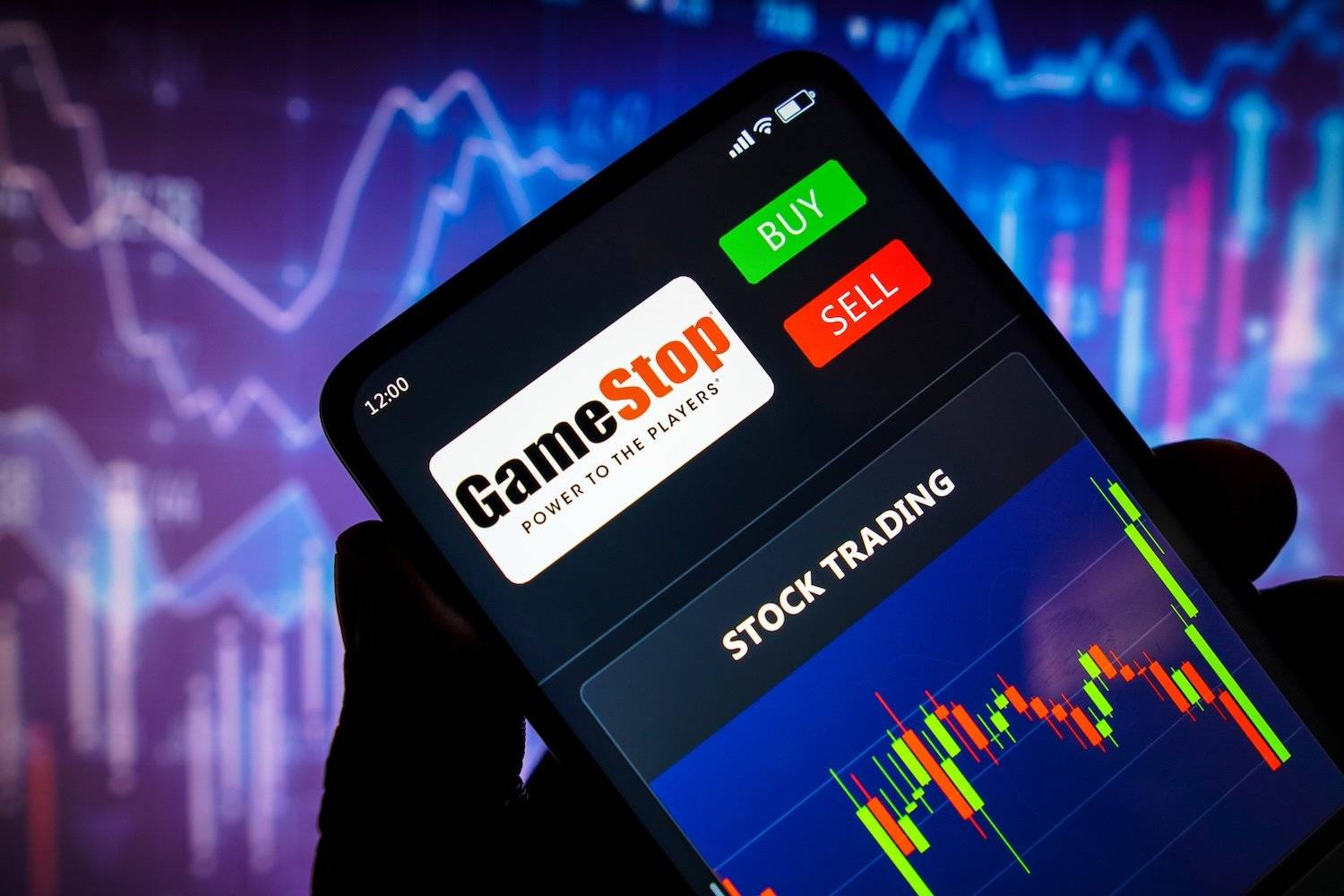 Cell phone showing GameStop stock chart.