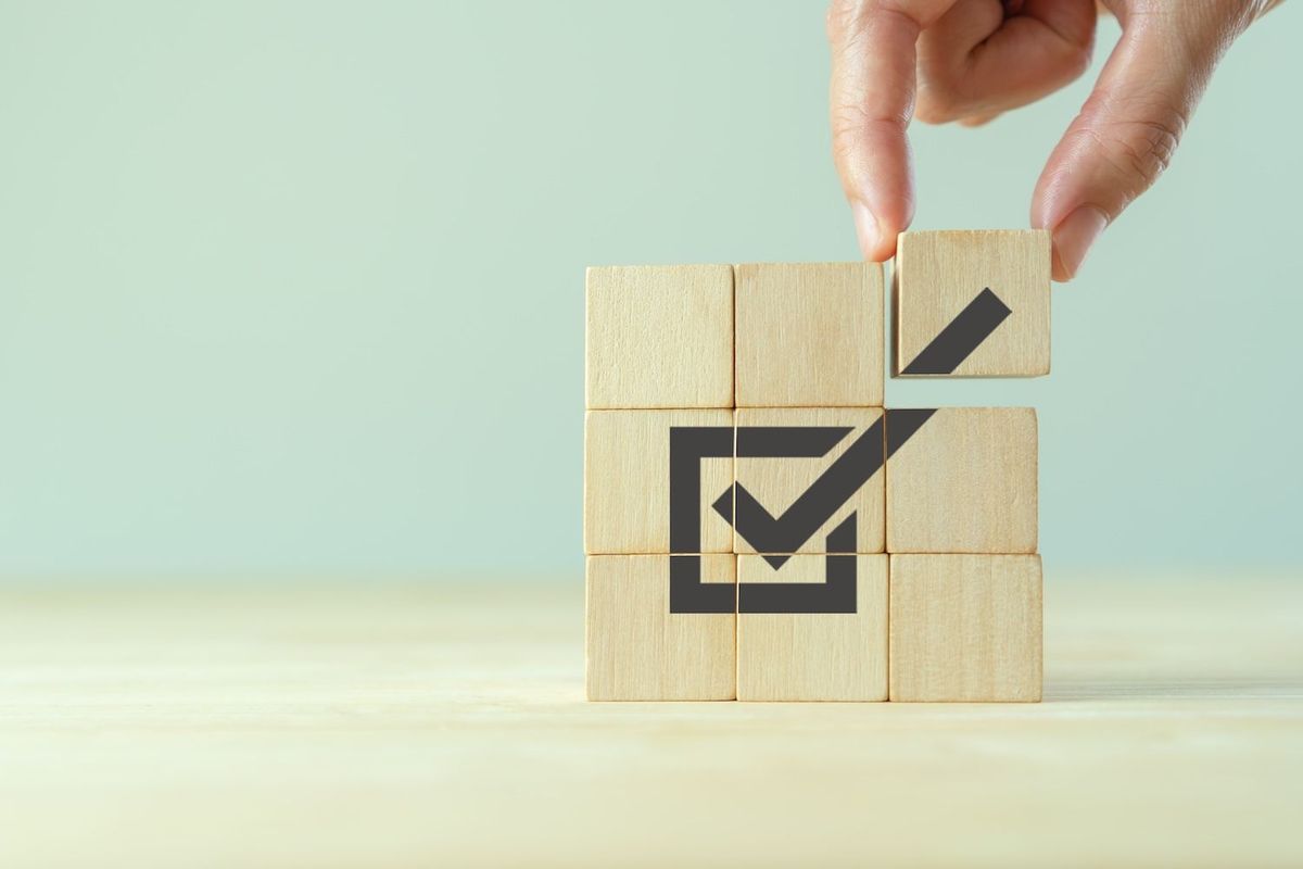 Check mark on wooden blocks.