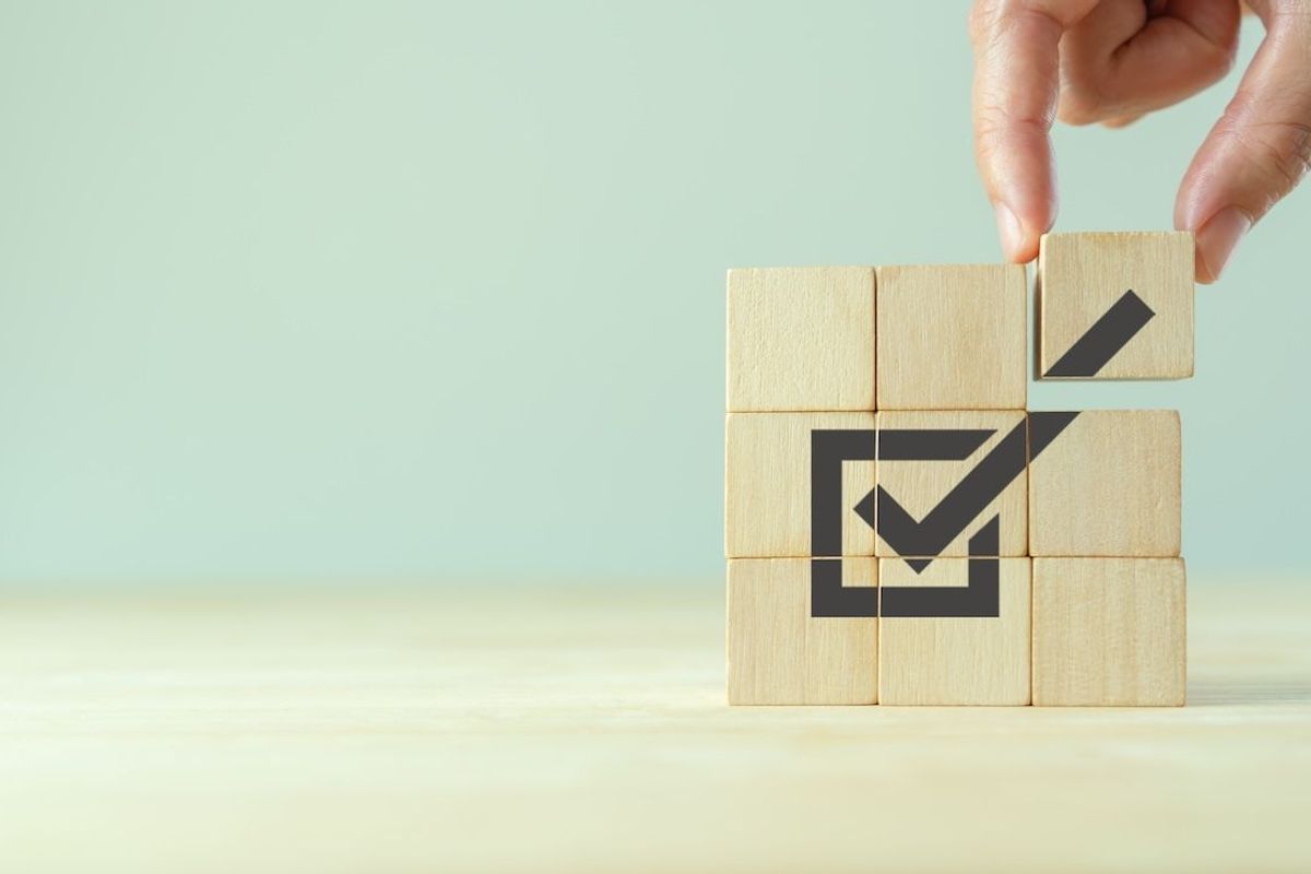Checkmark on wooden blocks.