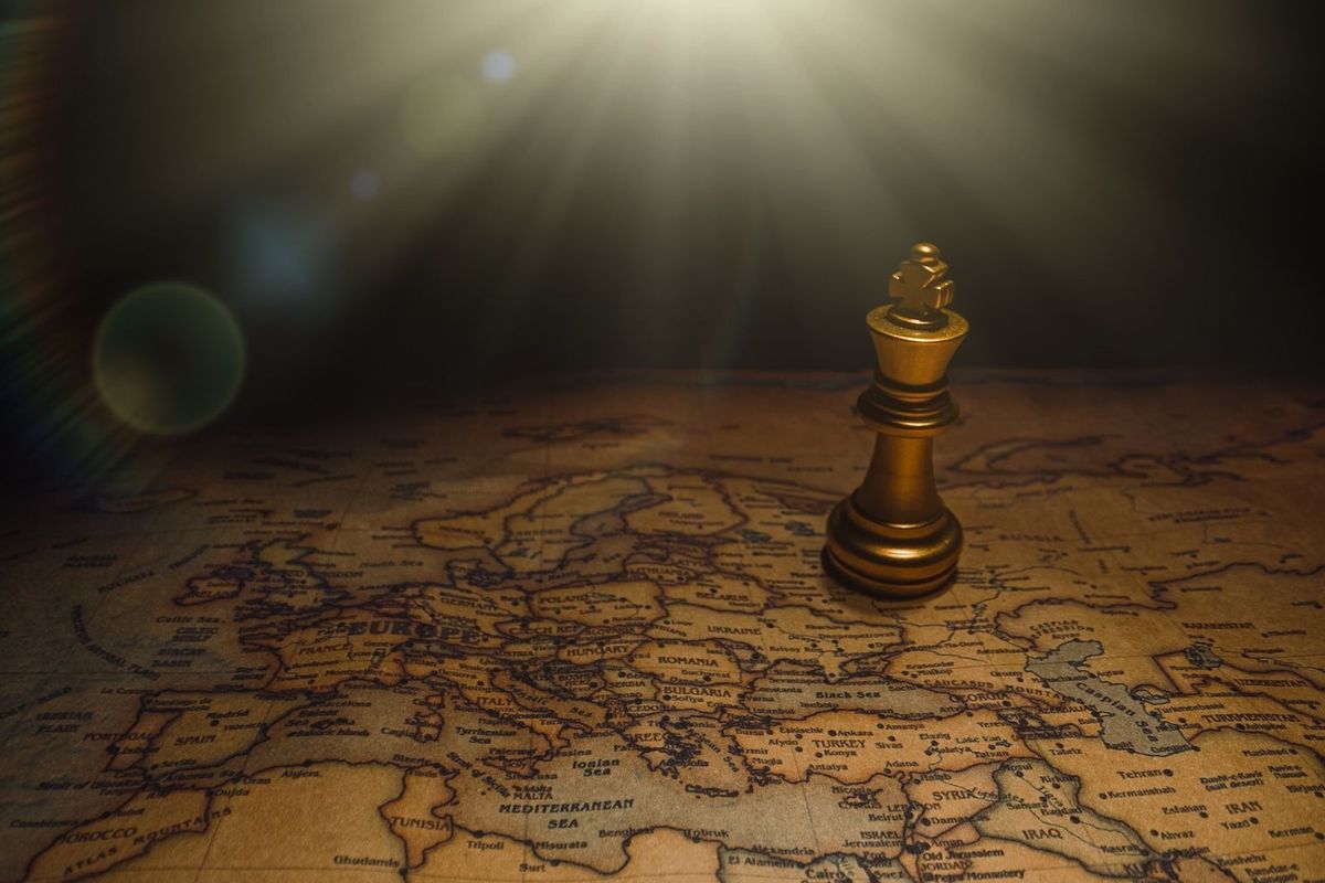 Chess piece on top of a globe.