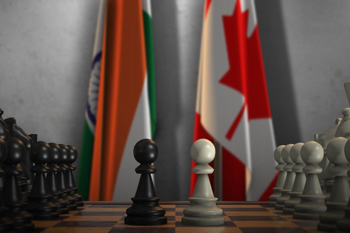 Chessboard with Indian and Canadian flags in the background.