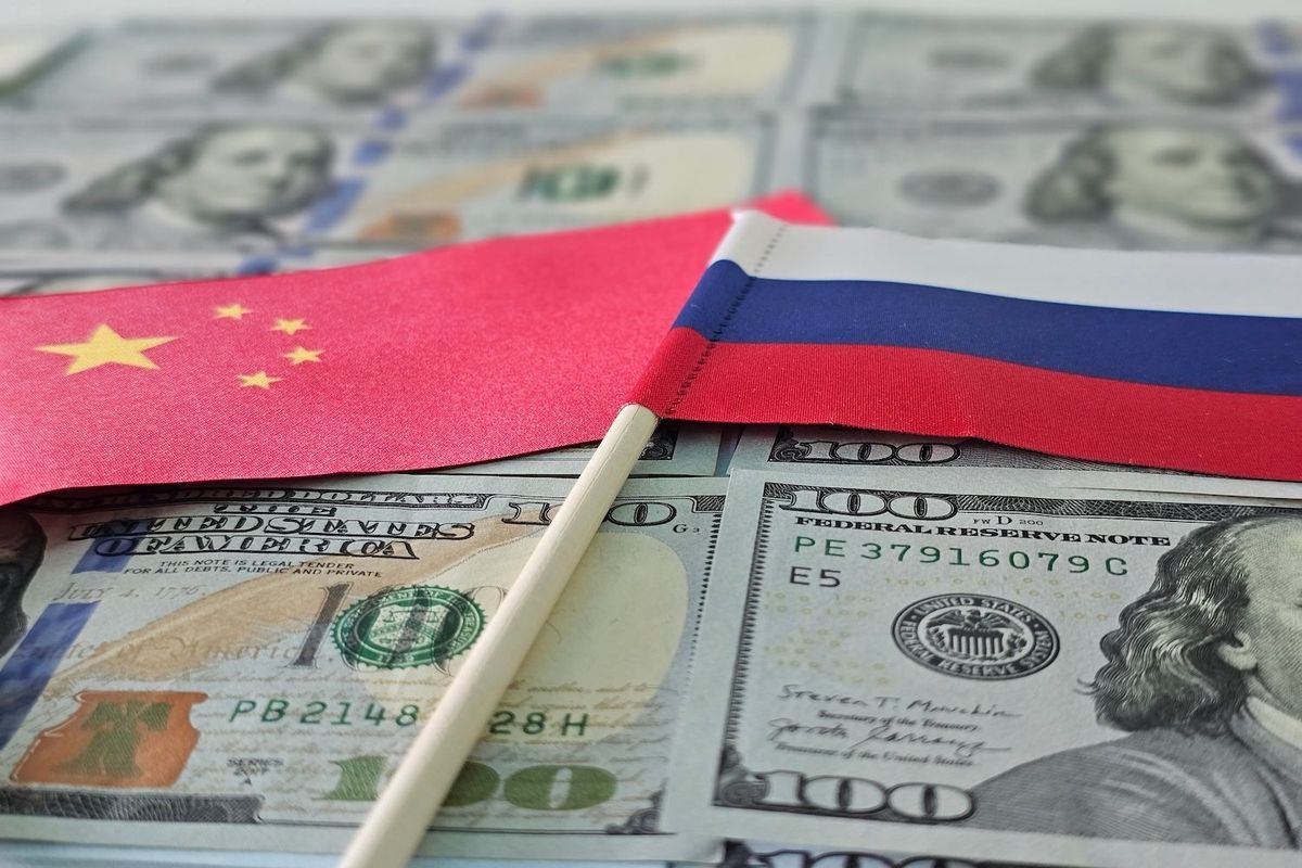 China's flag and Russia's flag on US$100 bills. 