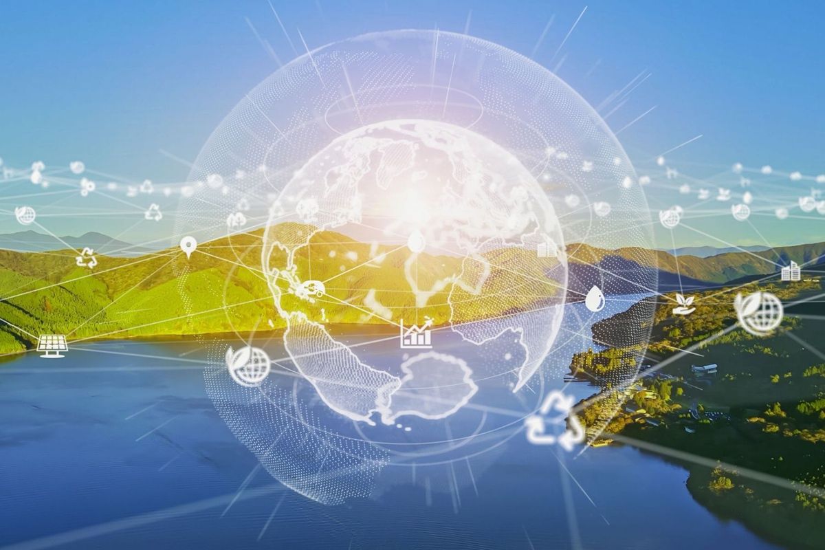 Cleantech concept — globe superimposed on river and mountains.