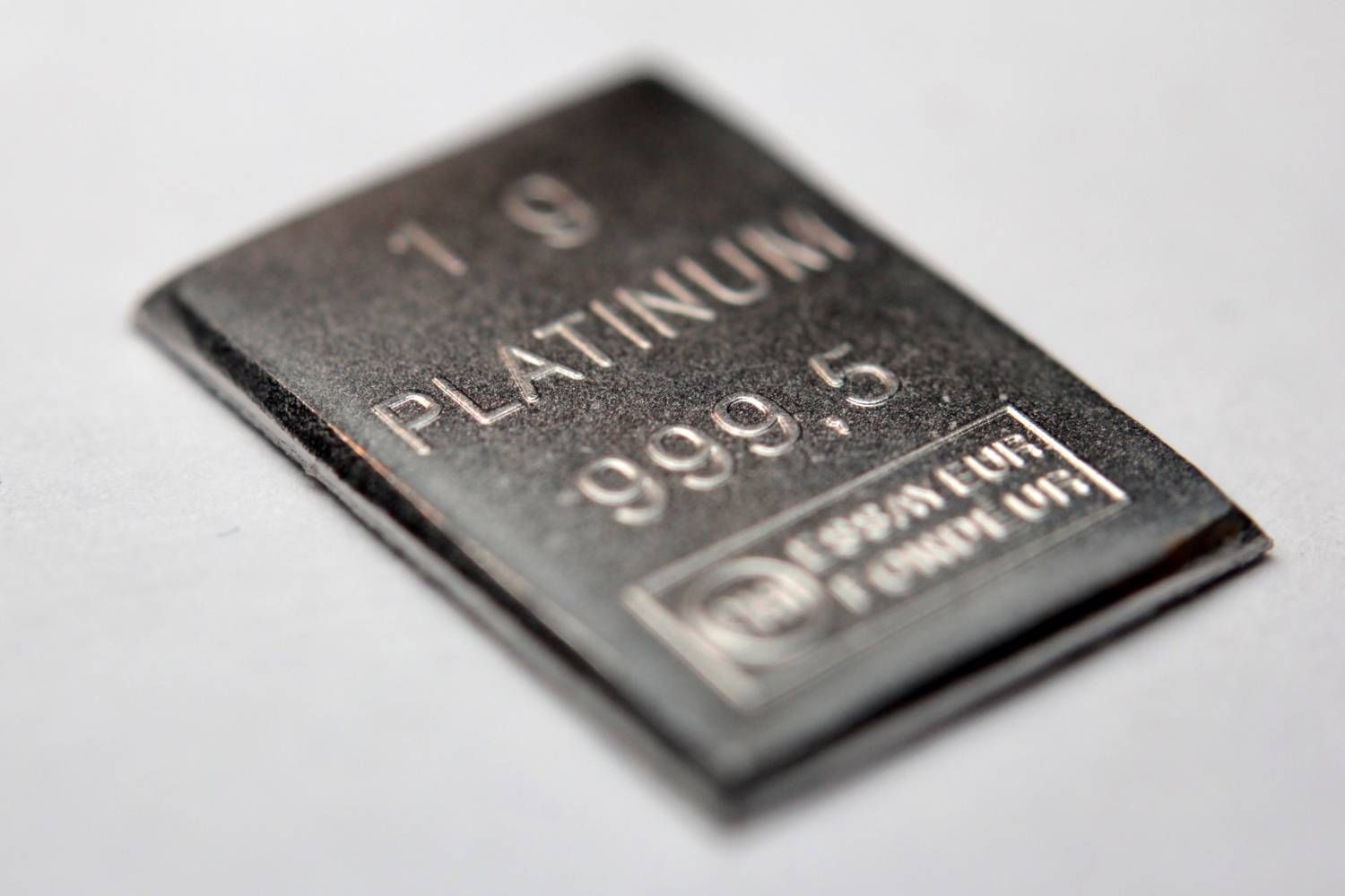 Closeup of a rectangular platinum bar with "999.5" purity marking.