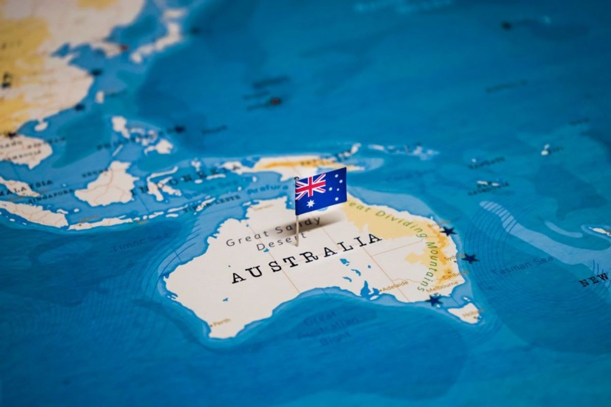 closeup of australia on world map with a small australia flag in the middle