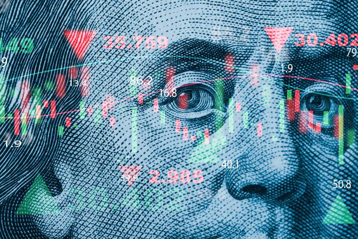Closeup of banknote with overlaid stock market data and charts.