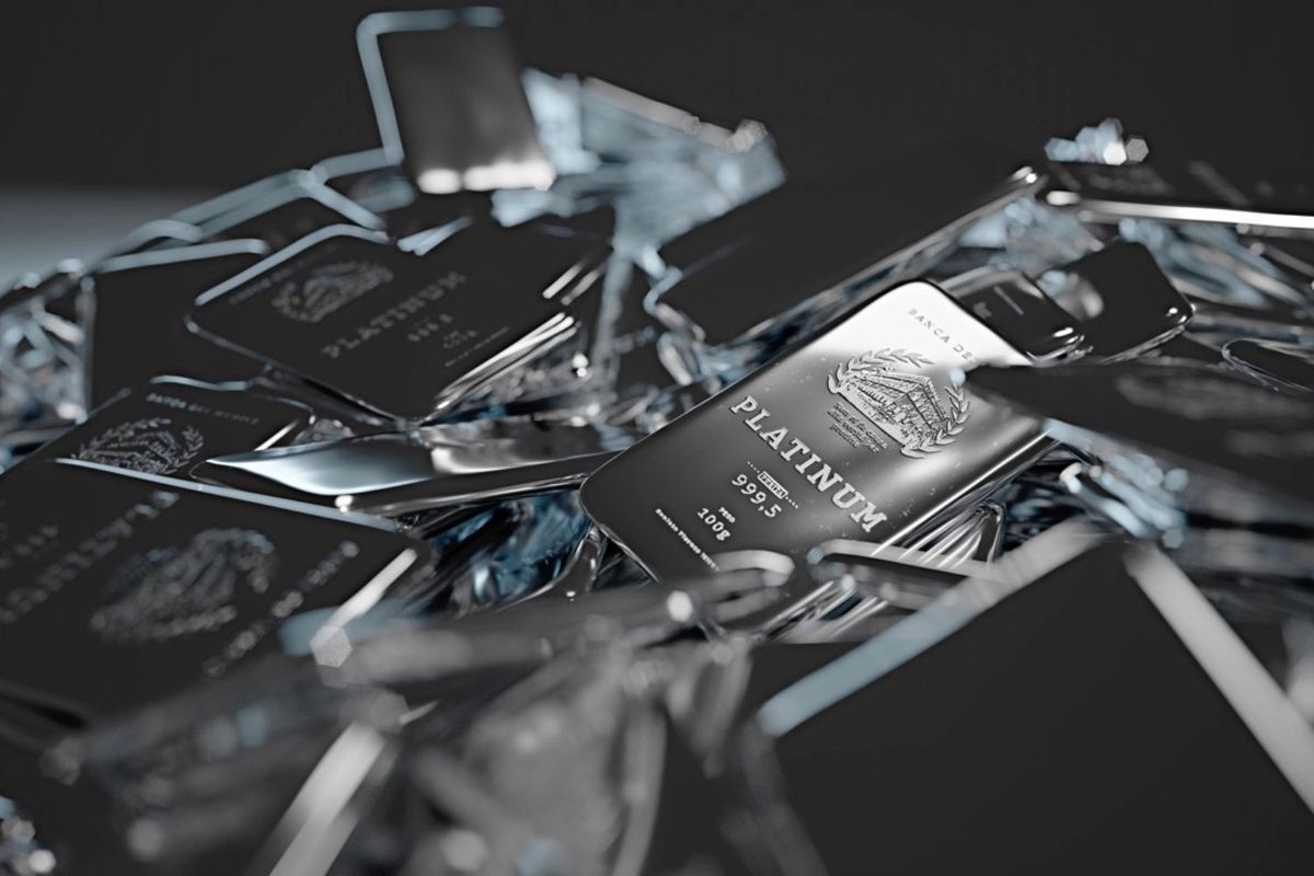 Closeup of shiny platinum bars stacked randomly against a dark background.