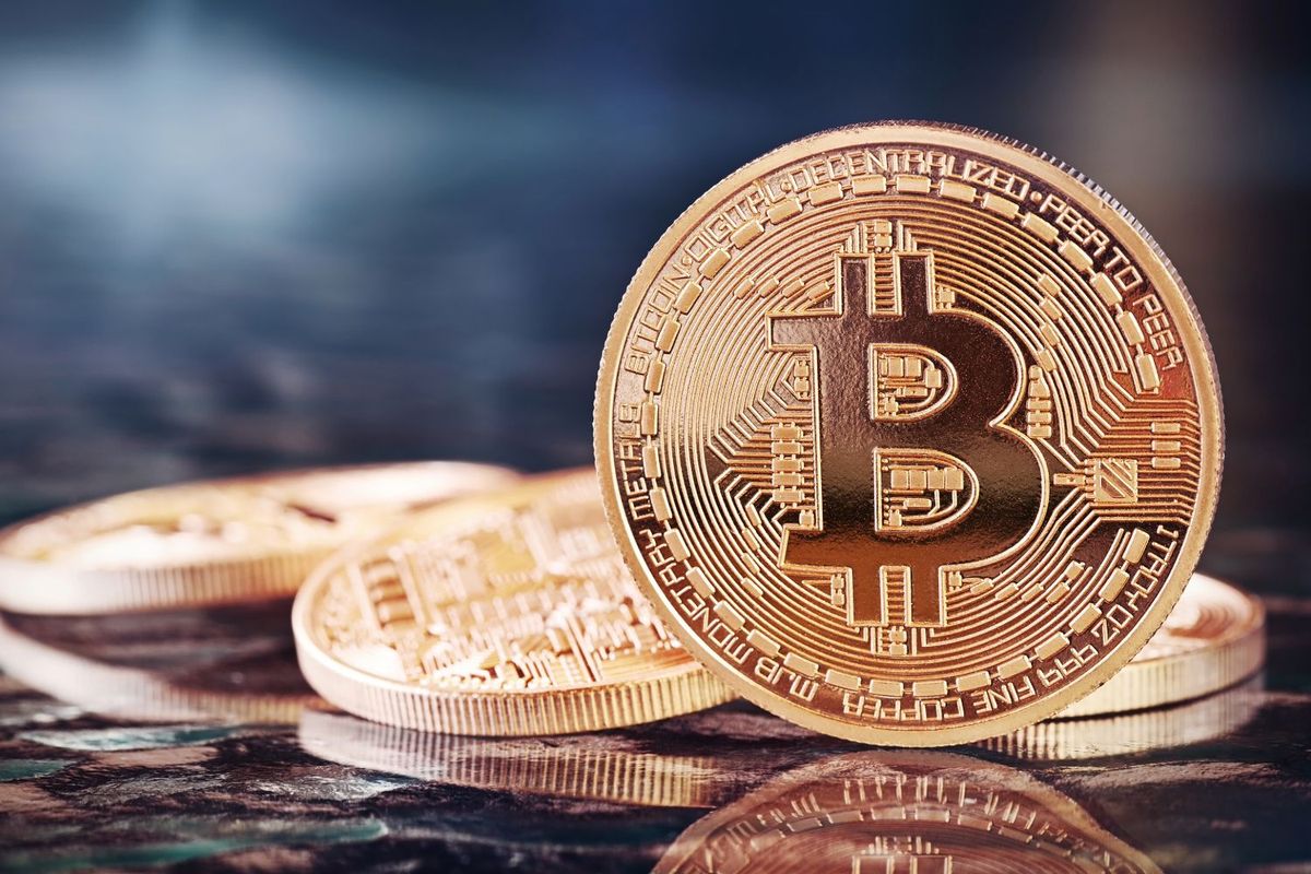 Closeup of stacked Bitcoin coins with a shiny metallic finish.