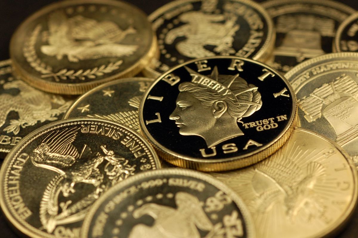 Closeup of various gold coins with liberty and eagle designs.