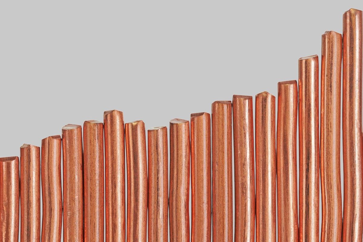 Copper metal tubes side by side ascending in height.
