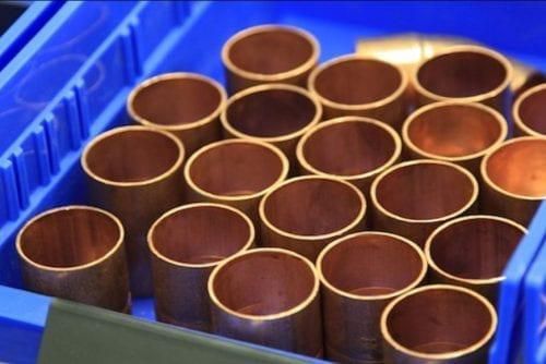copper pipes in a blue bin