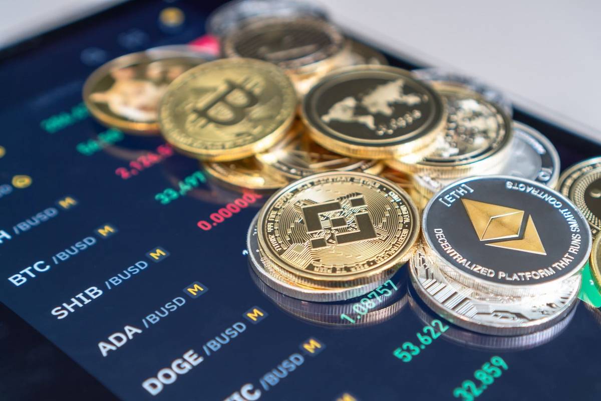 Crypto coins on tablet showing price quotes.