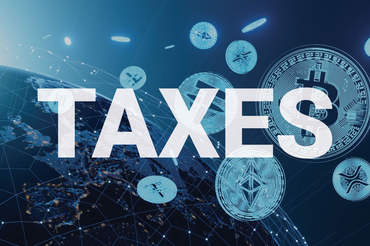 Cryptocurrencies overlayed with the word taxes. 