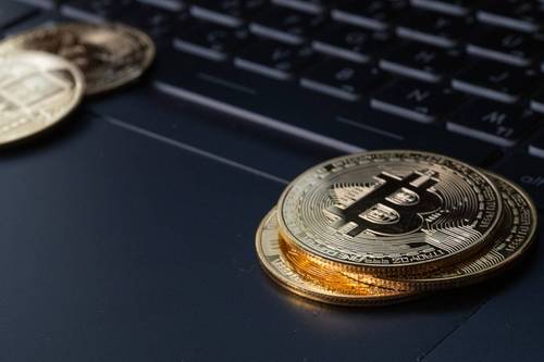 Cryptocurrency coins on keyboard.