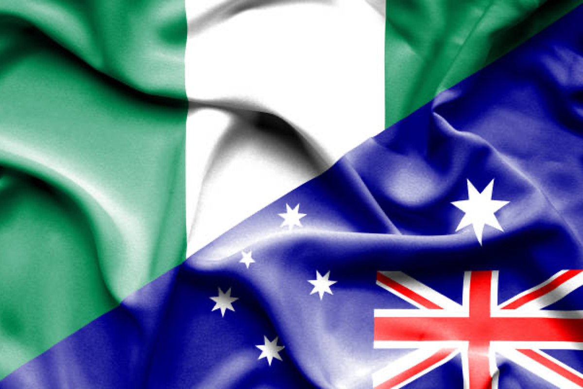 Diagonal split of Nigerian and Australian flags with fabric texture.