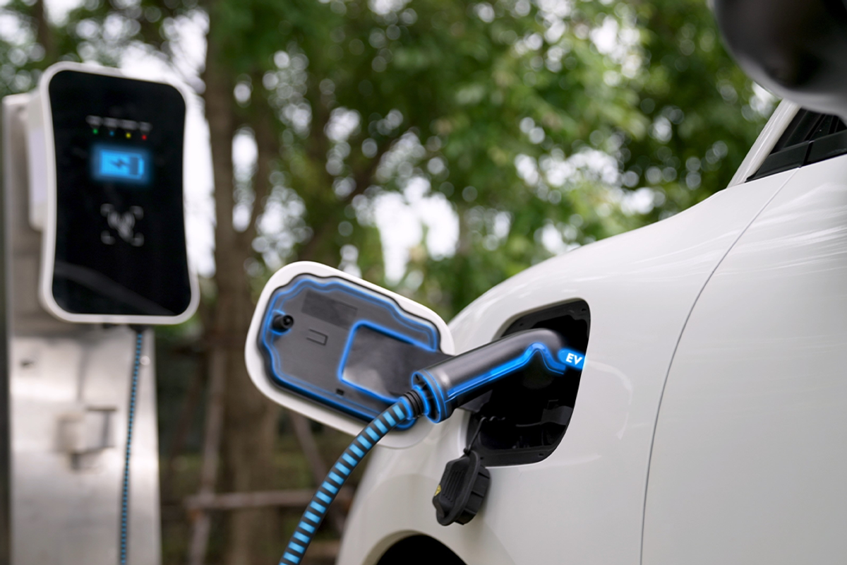 Electric car plugged into charging station.