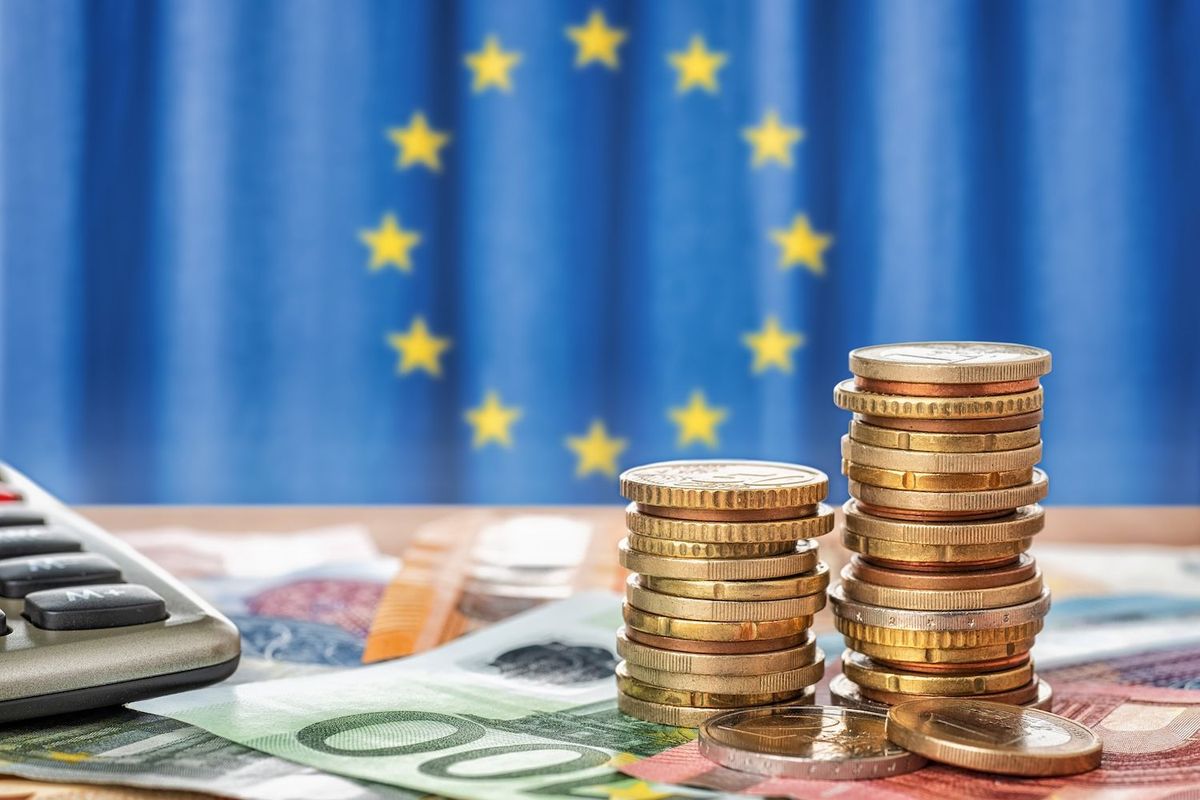 EU flag with coins and bills.
