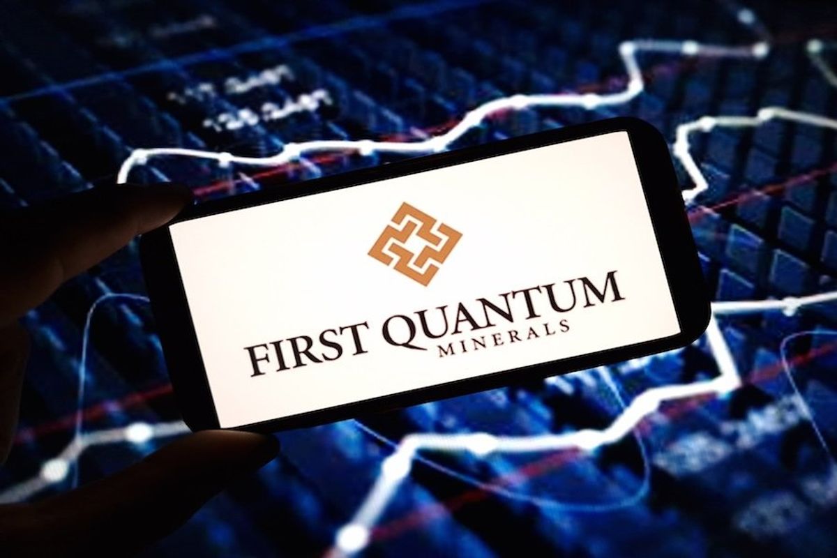 "First Quantum Mineral"s displayed on a smartphone in front of a stock screener.