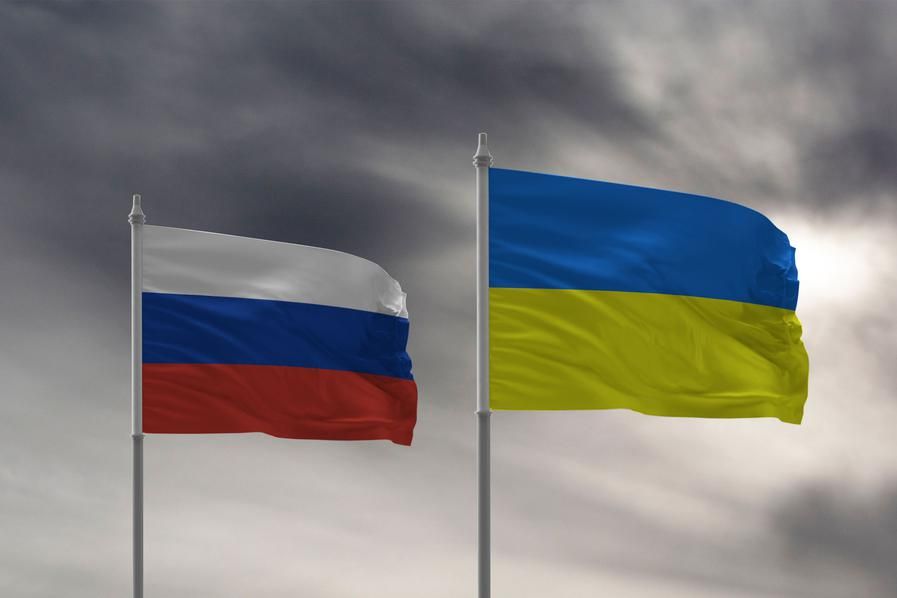 flags for russia and ukraine against dark sky