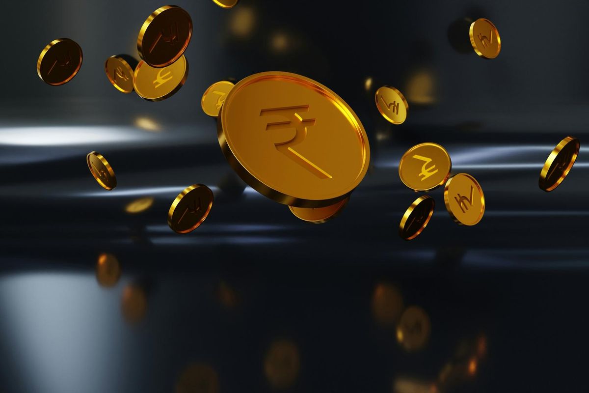 Floating gold coins with Indian rupee symbols on a dark background.