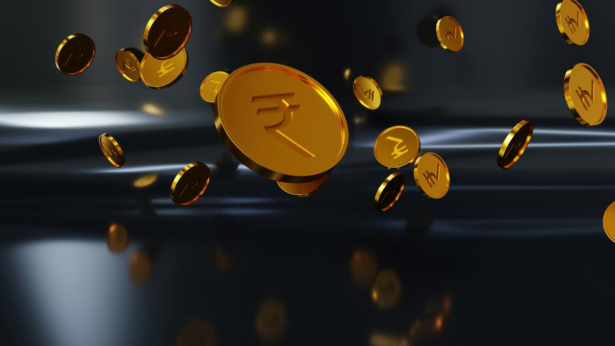 Floating gold coins with Indian rupee symbols on a dark background.