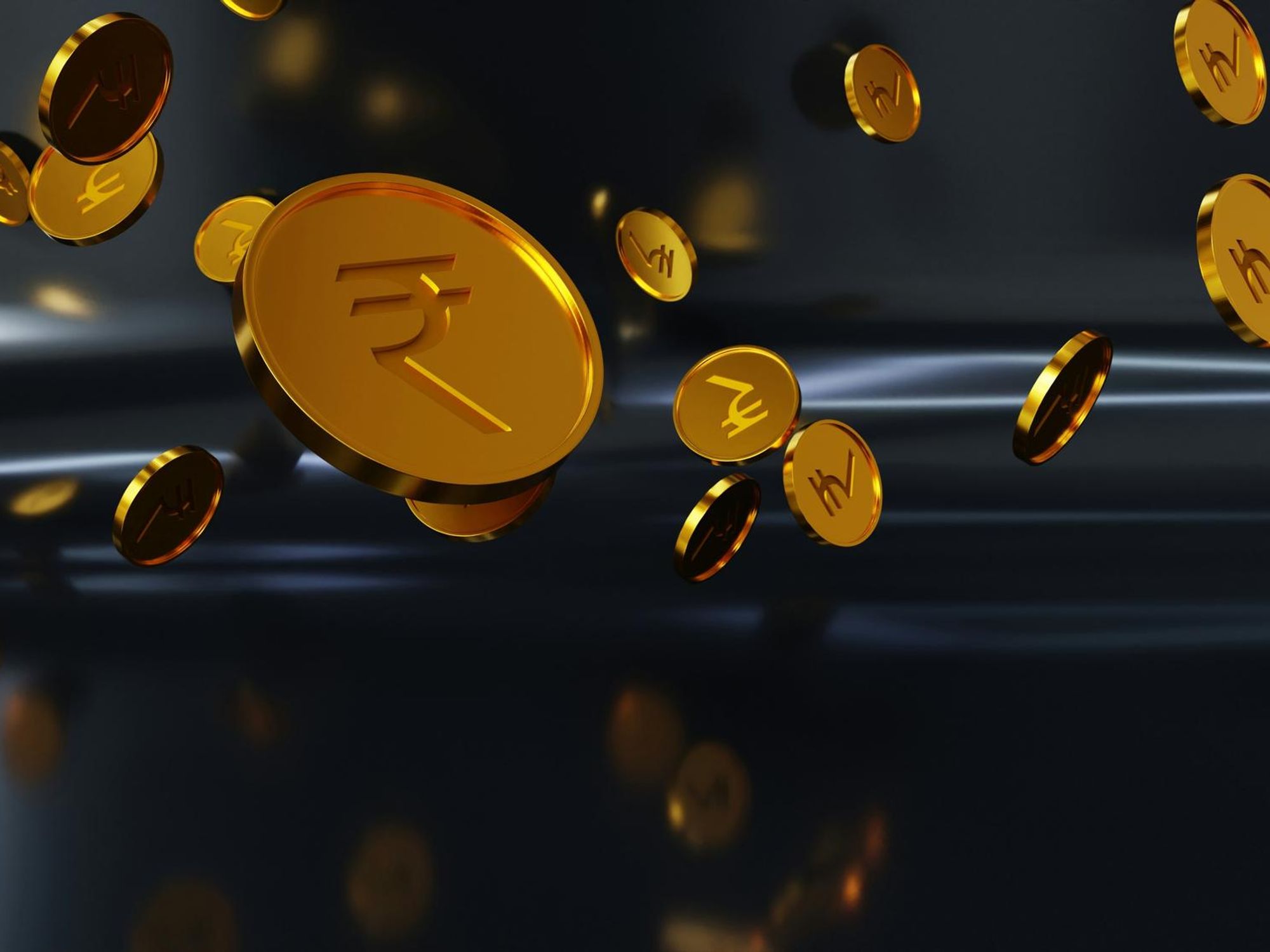 Floating gold coins with Indian rupee symbols on a dark background.