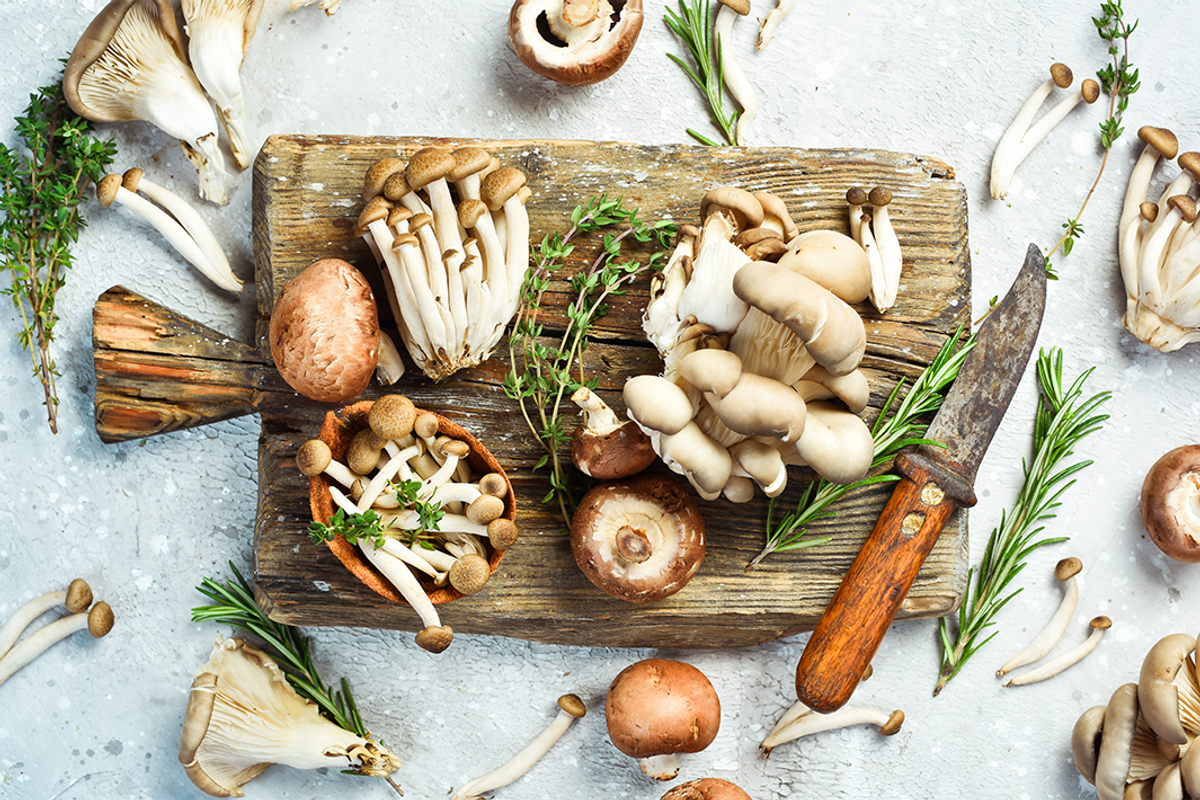 Functional mushrooms: Mushrooms on cutting board with knife.