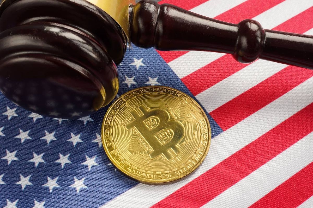Gavel and Bitcoin on a US flag, symbolizing cryptocurrency regulation.
