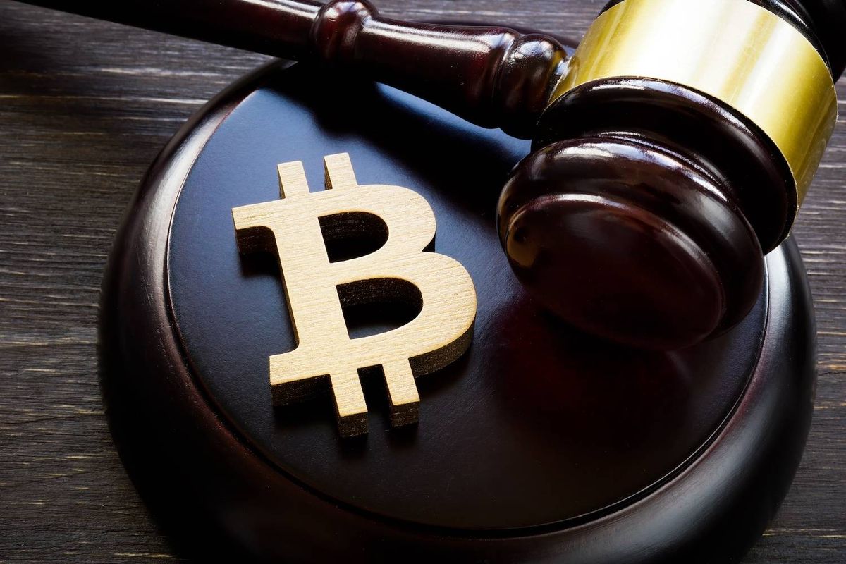 Gavel resting on Bitcoin symbol, suggesting legal implications of cryptocurrency.