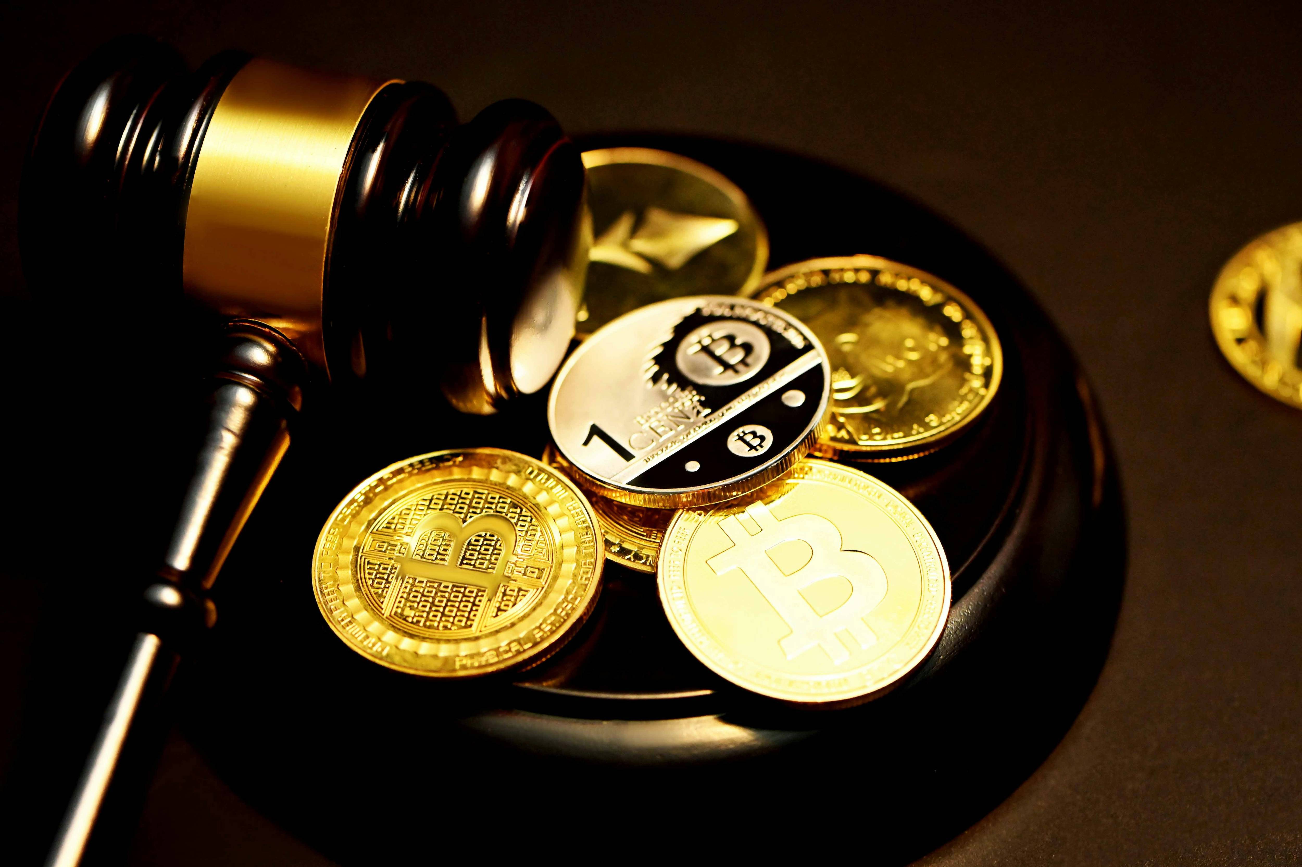 Gavel resting on cryptocurrencies, symbolizing legal issues in digital currency.