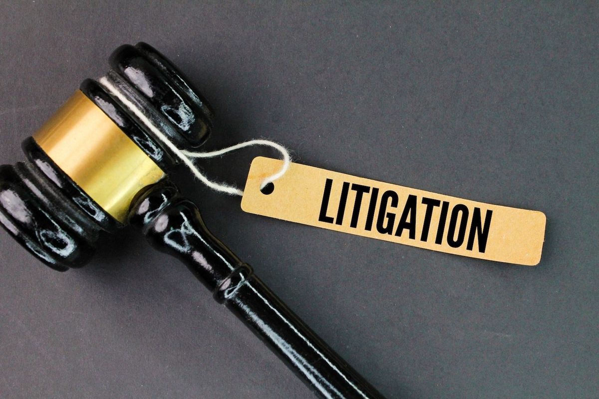 Gavel with "Litigation" tag on black background.
