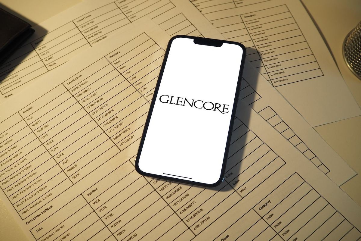 "Glencore" logo on phone screen.
