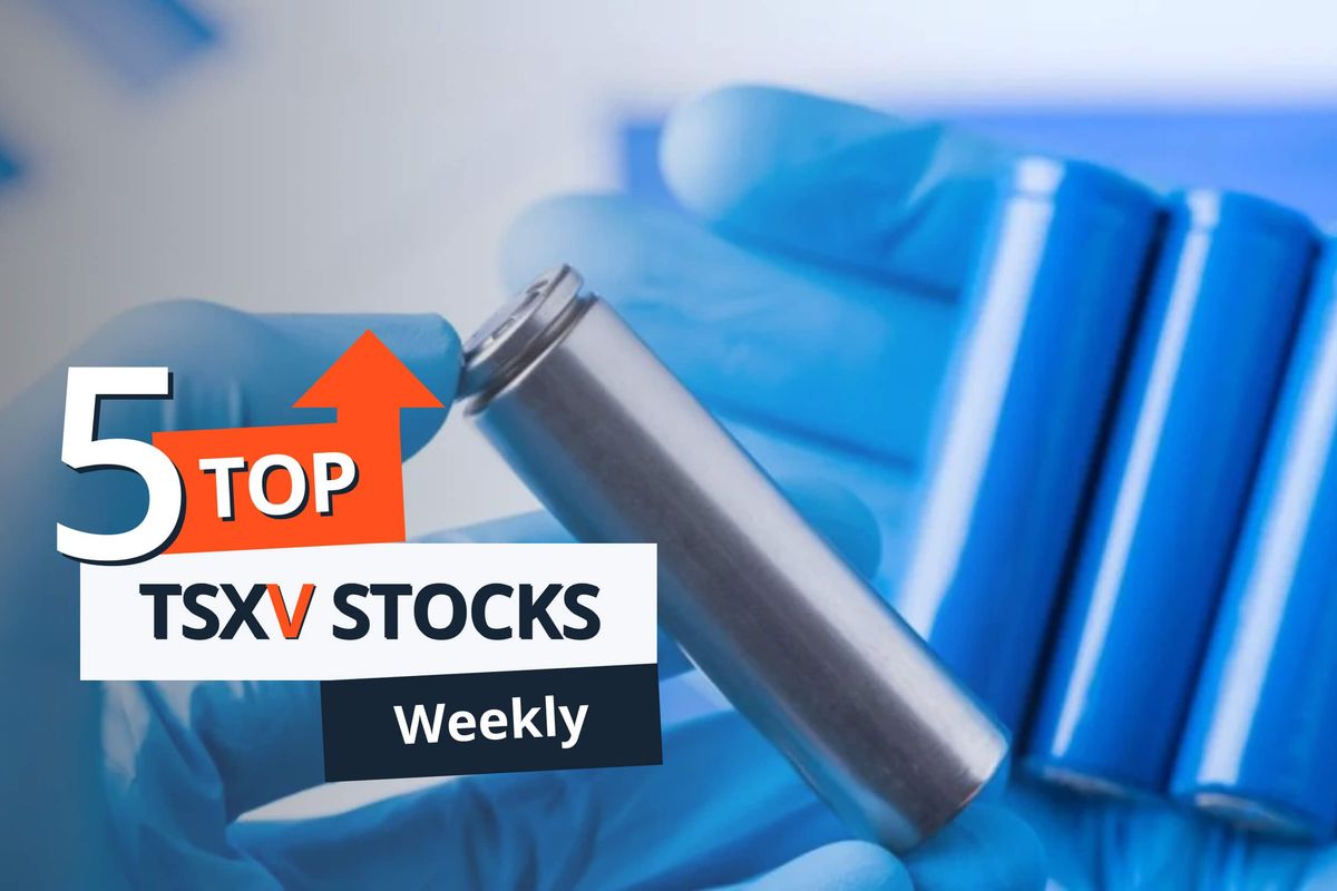 gloved hand holding batteries