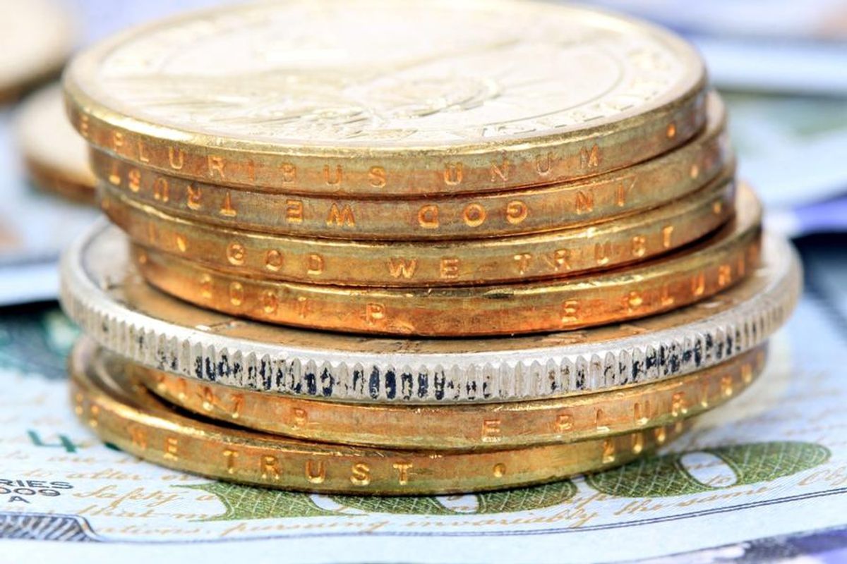 gold and silver coins with US$100 bill