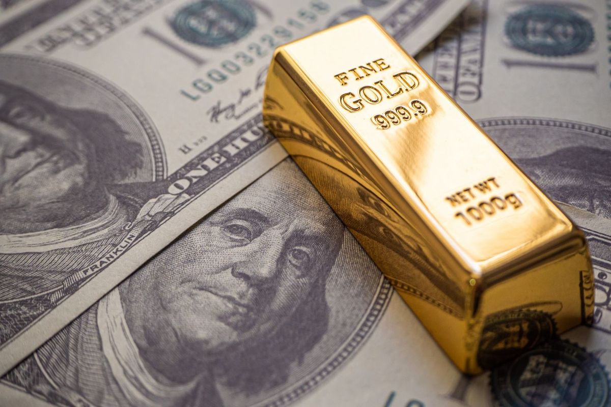 Gold bar and US money.