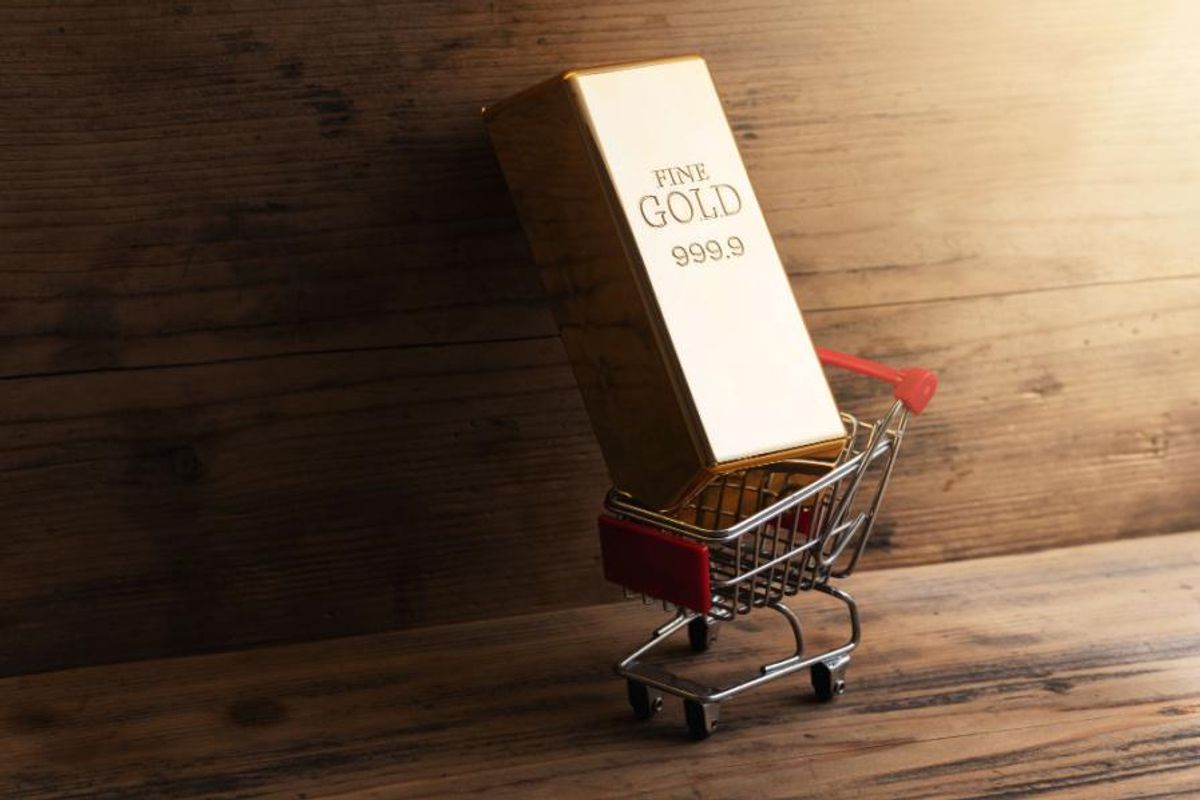 gold bar inside a small shopping cart