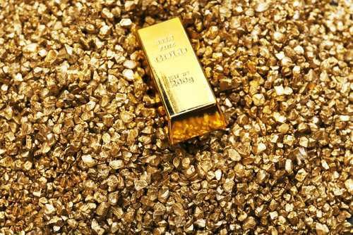 gold bar on a  pile of gold nuggets