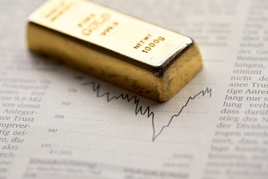 gold bar with stock chart