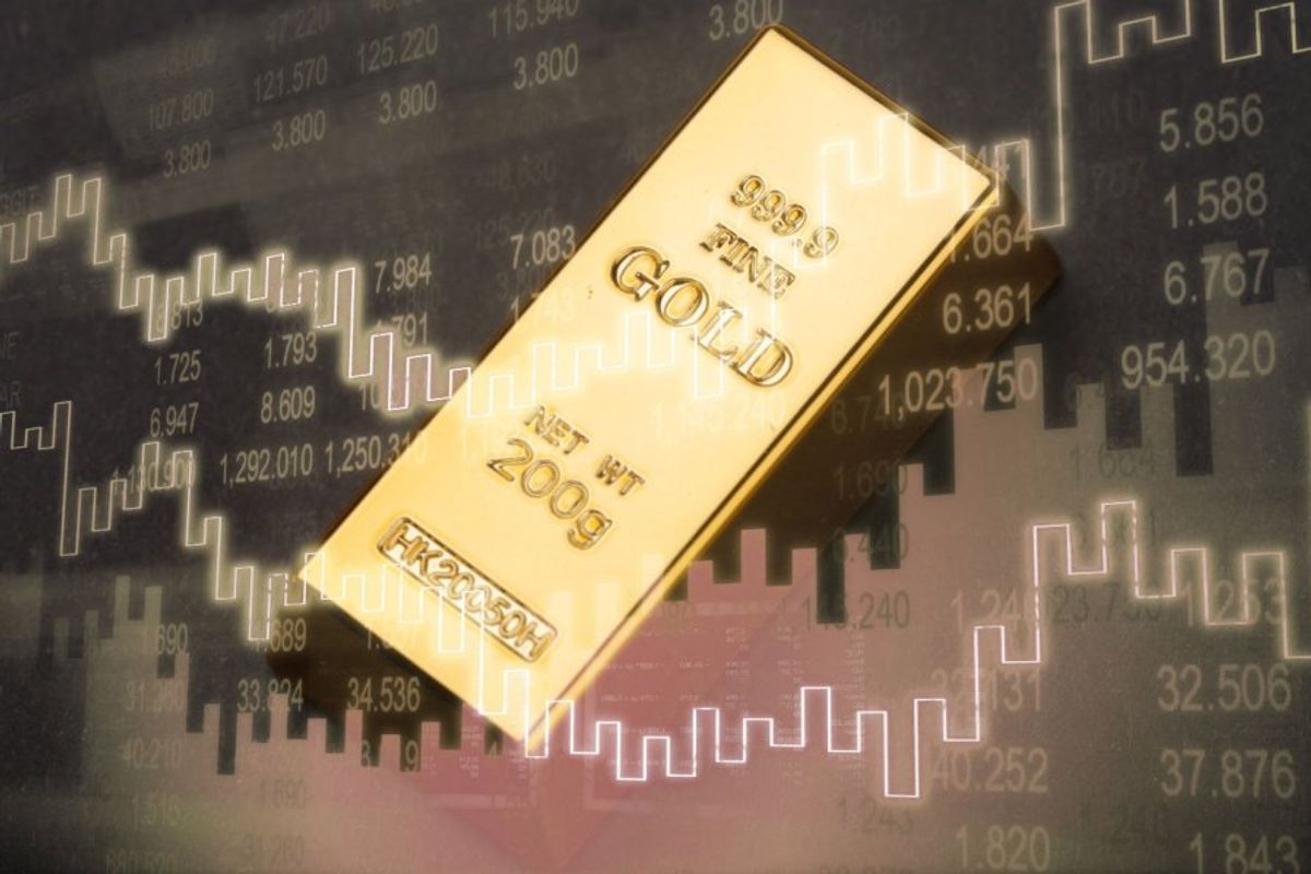 gold bar with stock charts in background