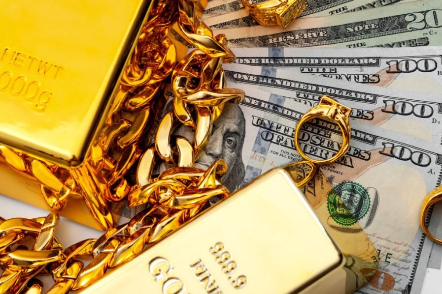 gold bars and jewelry with us money