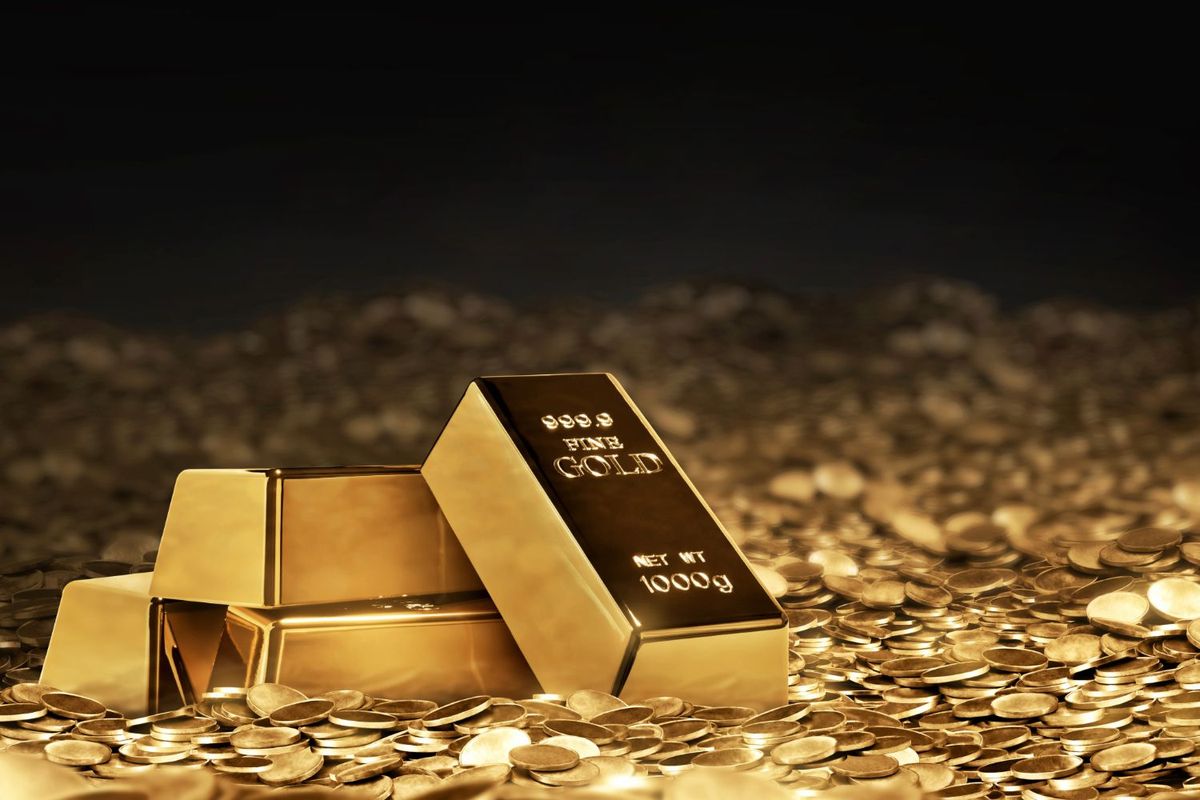 Gold bars and scattered coins on a shiny surface.
