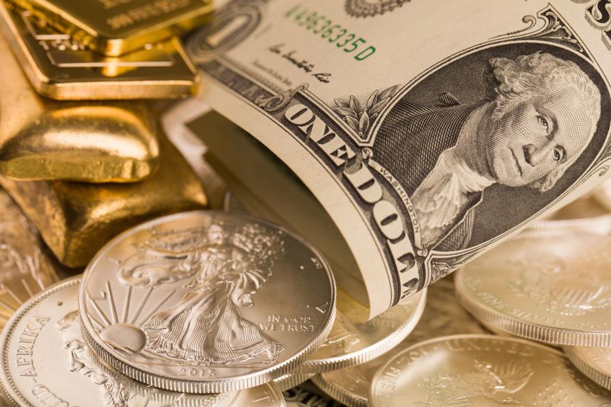 gold bars and silver coins with dollar bill
