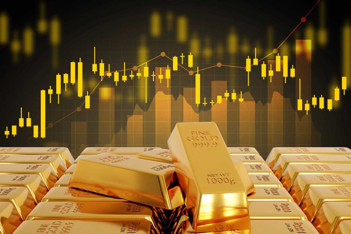 Gold bars in front of a rising stock market graph.