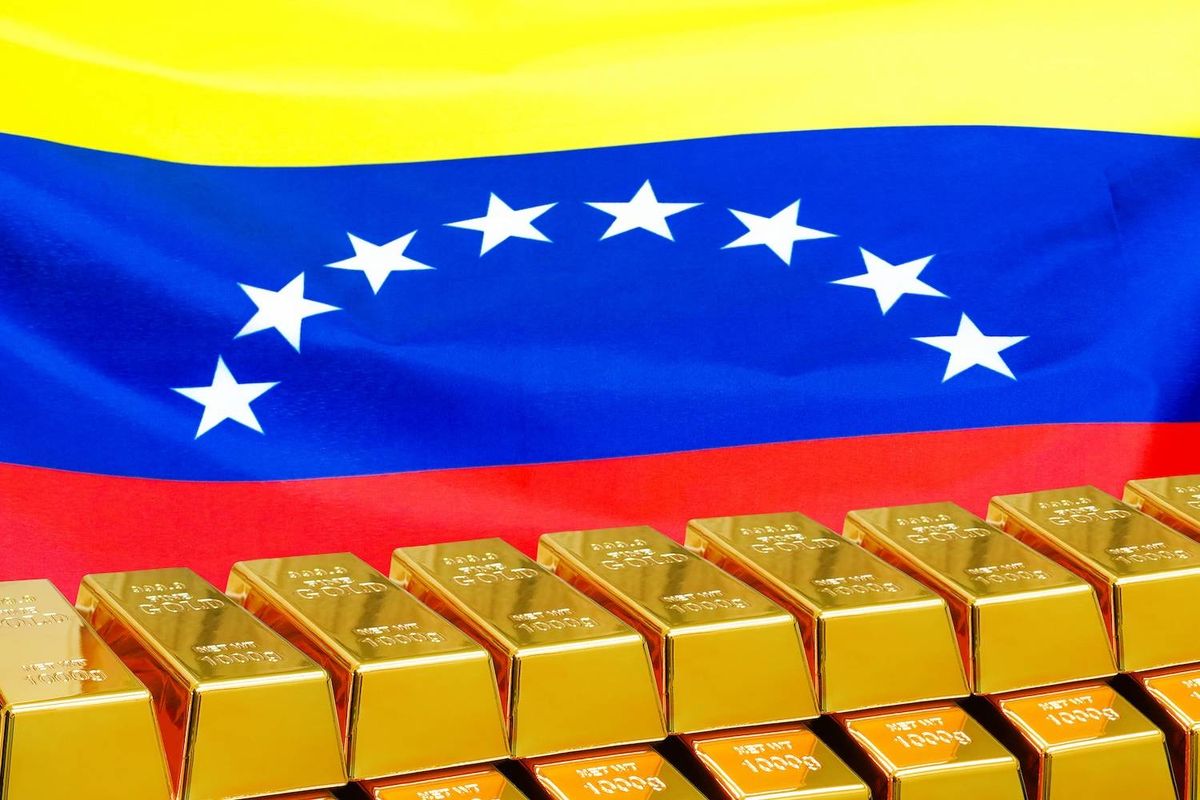 Gold bars in front of the Venezuelan flag.