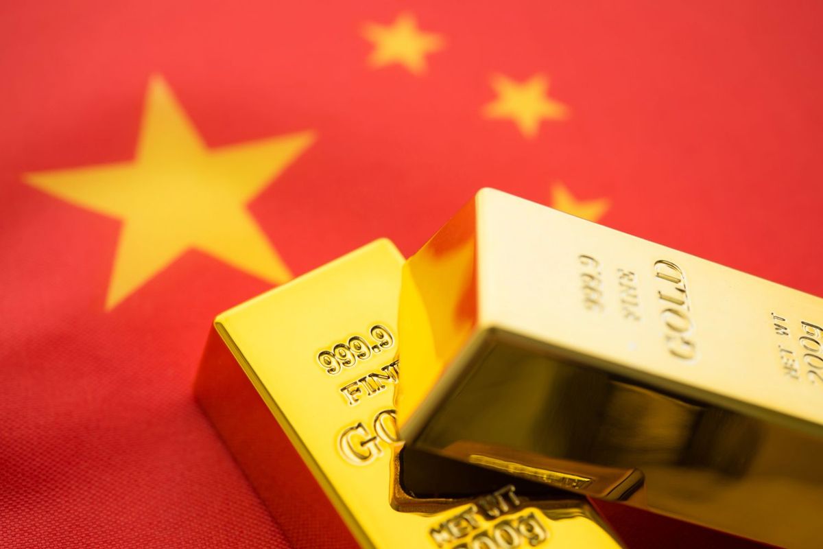 Gold bars on a Chinese flag background.